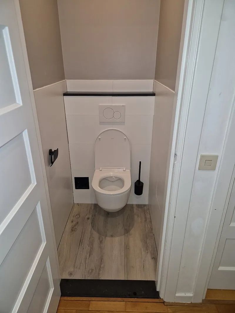 Hangend toilet met zwarte accessoires — toiletrenovatie in Korrewegwijk door BontBouw
