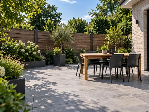 Bestraat terras met keramische tegels en een eettafel in een tuin in Groningen